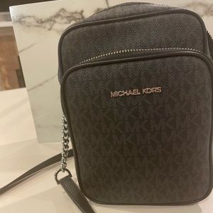 Michael Kors cross body bag. charcoal grey with MK logo insignia. Lightly used.